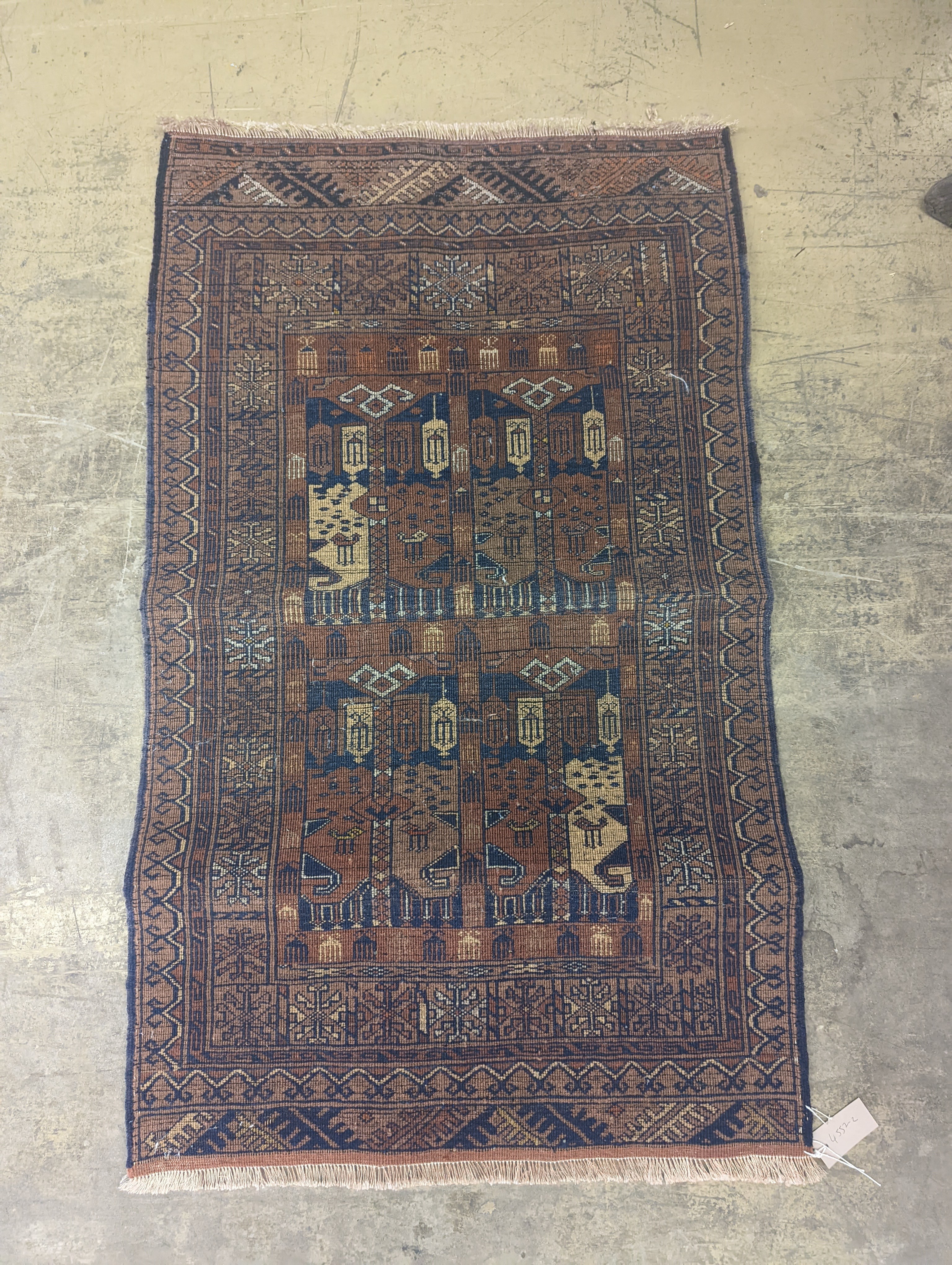 An Afghan pink ground rug, 120 x 71cm